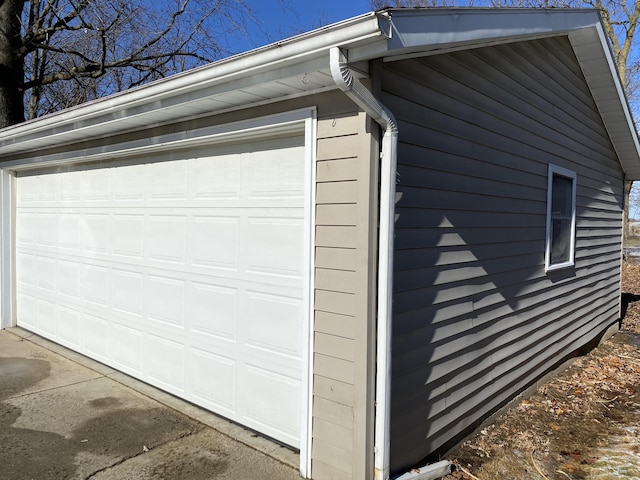 view of property exterior featuring a garage and an outbuilding