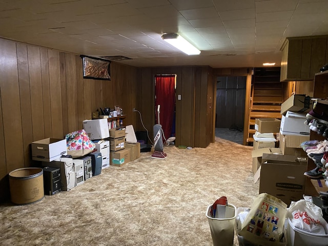 interior space with carpet floors and wood walls