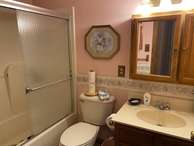 full bathroom featuring bath / shower combo with glass door, vanity, and toilet