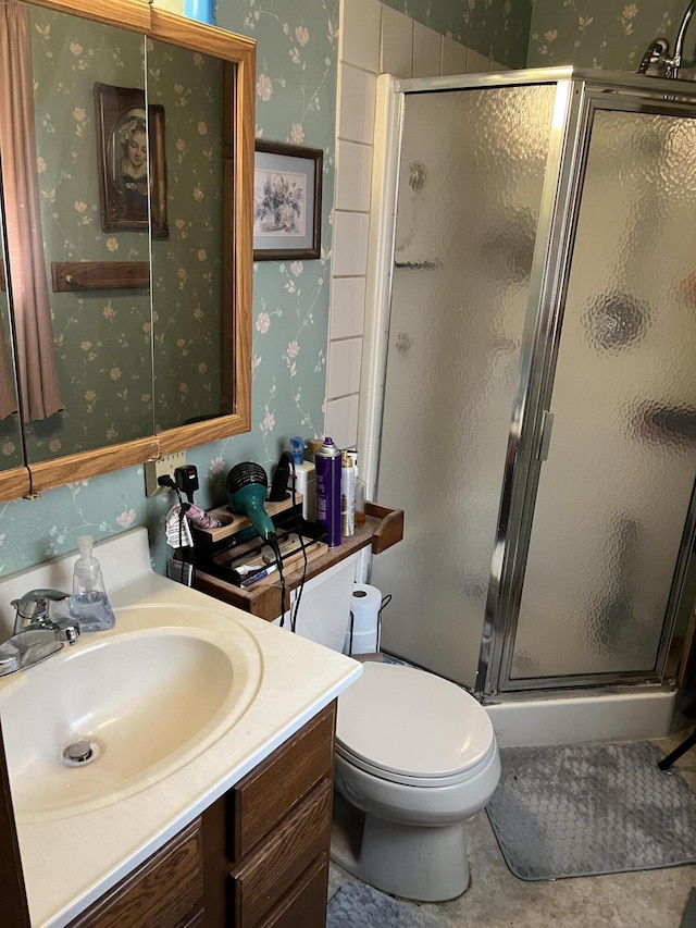 bathroom with vanity, toilet, and walk in shower