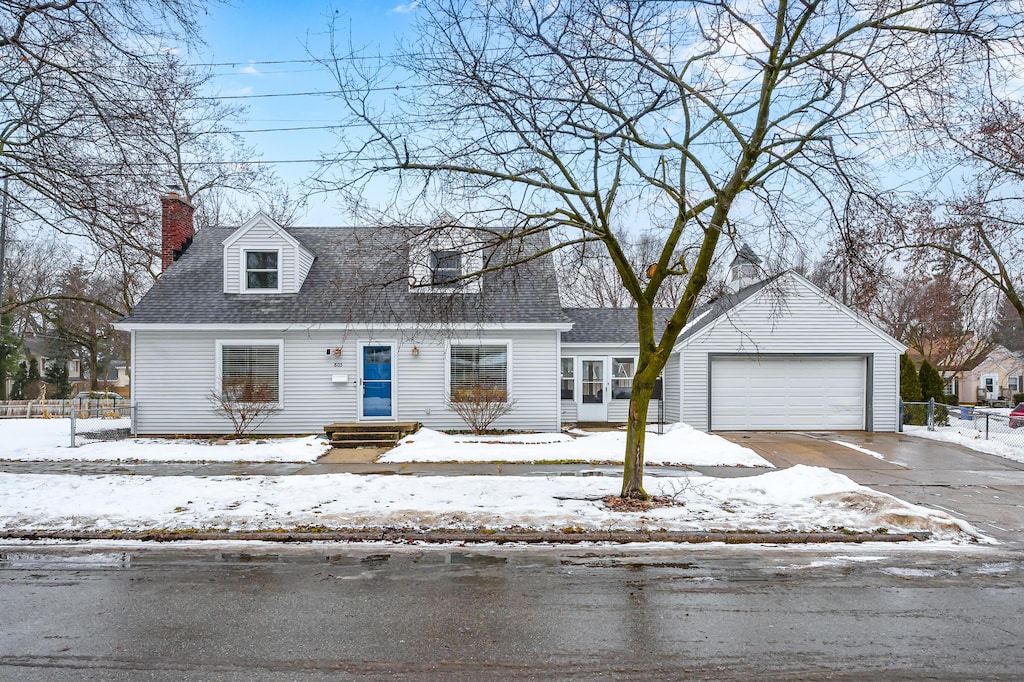 new england style home with a garage