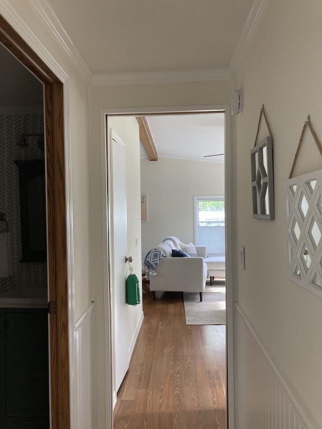 corridor with crown molding and light wood-type flooring