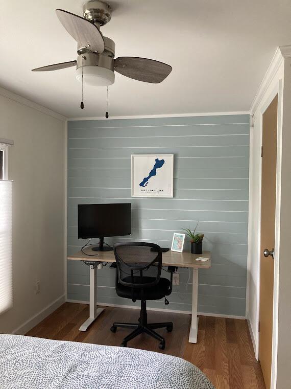 office area featuring ornamental molding, dark wood-type flooring, and ceiling fan