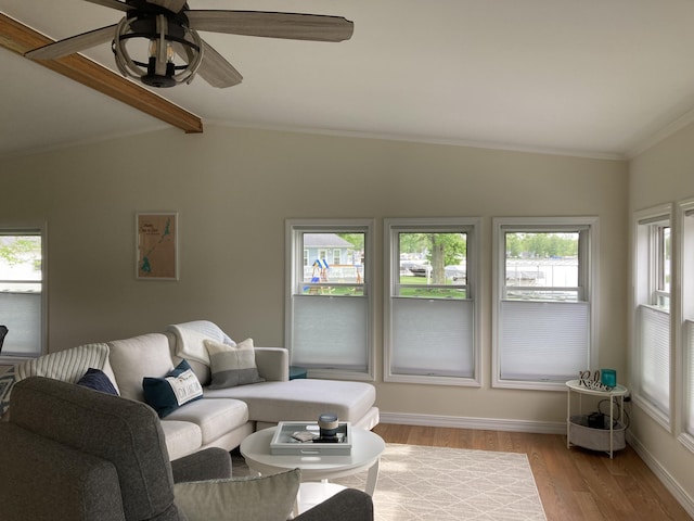 living room with vaulted ceiling with beams, crown molding, light hardwood / wood-style floors, and ceiling fan