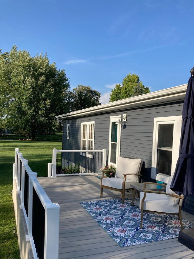 wooden deck featuring a yard