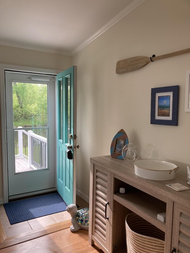 doorway to outside featuring crown molding and light hardwood / wood-style flooring