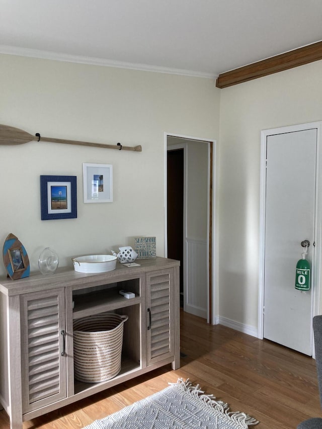 interior space with hardwood / wood-style flooring and crown molding