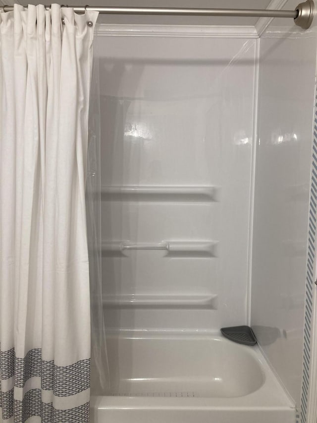 bathroom featuring shower / tub combo with curtain