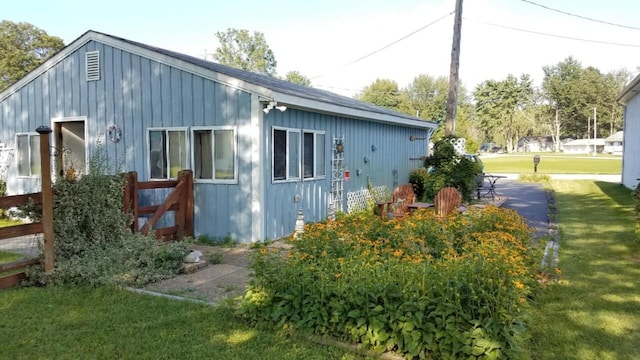 view of side of property with a lawn