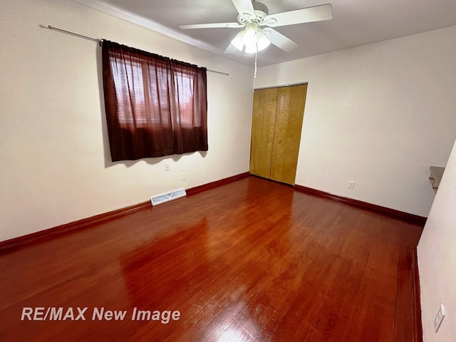 empty room with hardwood / wood-style flooring and ceiling fan