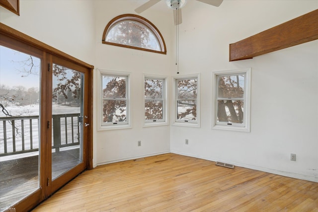 unfurnished sunroom with ceiling fan