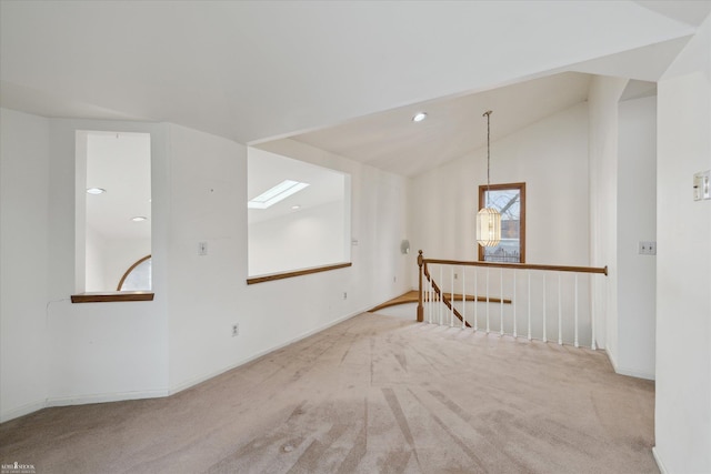 additional living space featuring lofted ceiling and light carpet