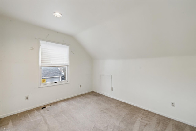 additional living space with lofted ceiling and light colored carpet