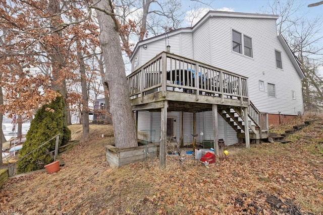 rear view of property featuring a deck