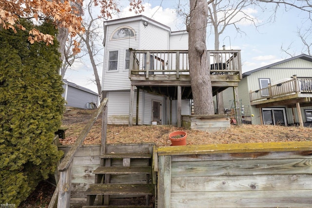 rear view of property featuring a deck