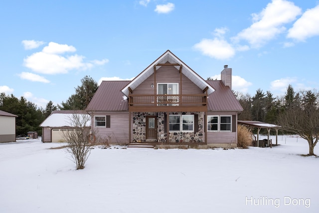 9322 E 56th St, Newaygo, MI 49337 - chalet / cabin featuring metal roof, stone siding, covered porch, and a chimney