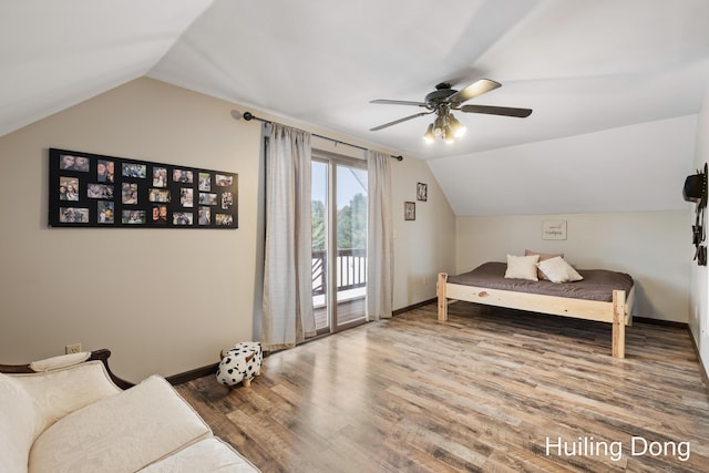 bedroom featuring hardwood / wood-style floors, access to outside, ceiling fan, and vaulted ceiling