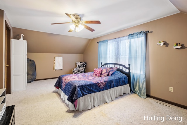 carpeted bedroom with vaulted ceiling and ceiling fan