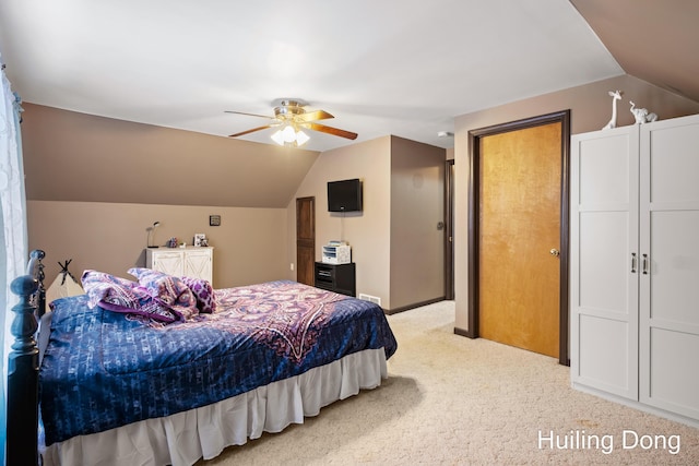 bedroom featuring vaulted ceiling, light colored carpet, and ceiling fan