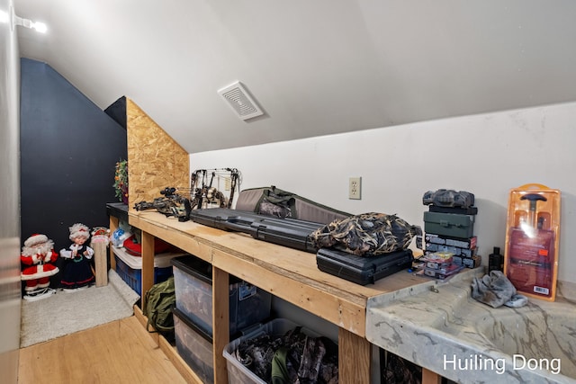 misc room with hardwood / wood-style flooring and lofted ceiling