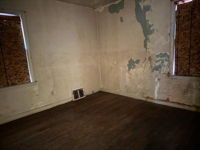 unfurnished room featuring dark hardwood / wood-style flooring