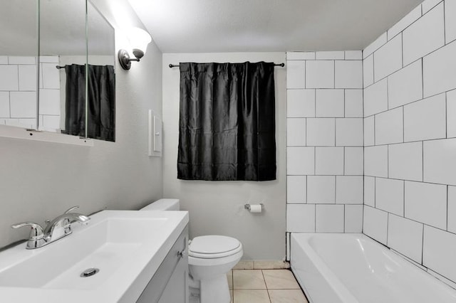 full bathroom with tile patterned flooring, vanity, tiled shower / bath combo, and toilet