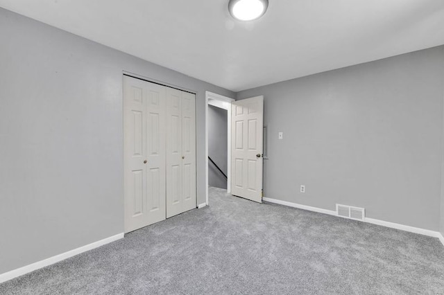 unfurnished bedroom with a closet and carpet