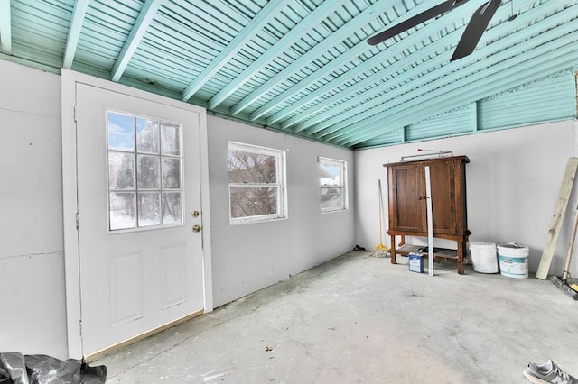 unfurnished sunroom featuring vaulted ceiling