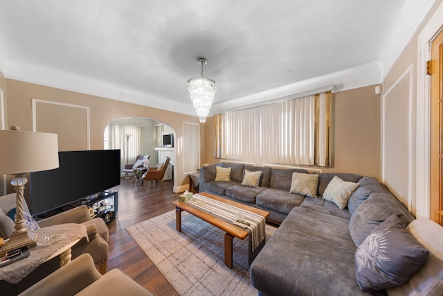 living room featuring dark wood-type flooring and a notable chandelier