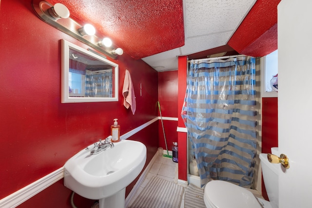 bathroom featuring sink, tile patterned floors, a textured ceiling, and toilet