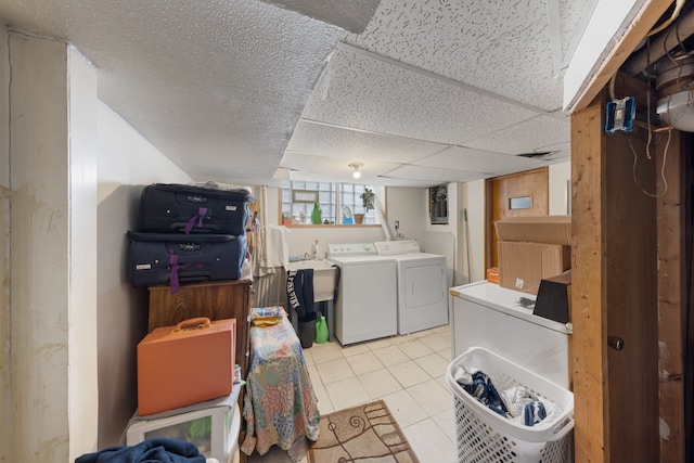 washroom with light tile patterned flooring and washer and dryer