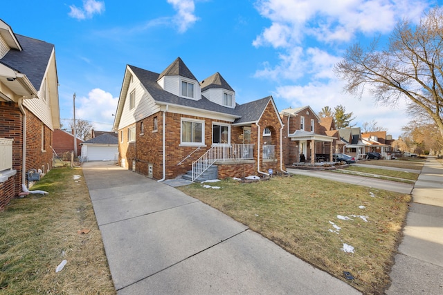 view of front of home featuring an outbuilding, a garage, and a front yard