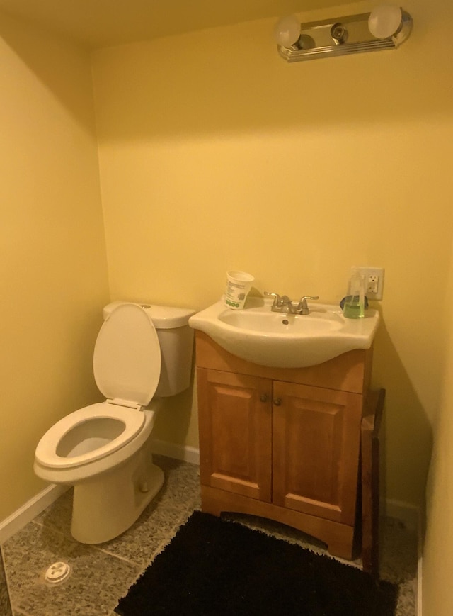 bathroom with tile patterned floors, vanity, and toilet