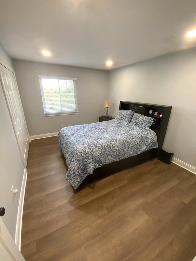 bedroom with dark hardwood / wood-style flooring