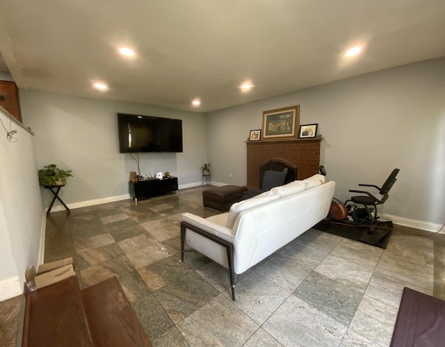 living room featuring a brick fireplace