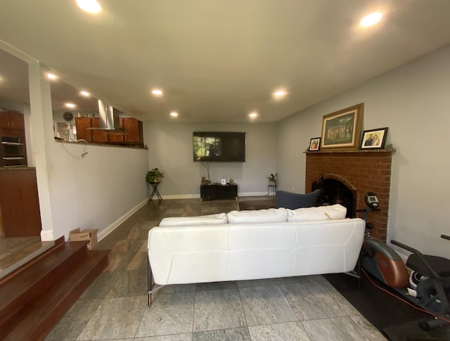 living room featuring a brick fireplace