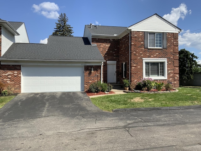 front facade featuring a garage and a front lawn