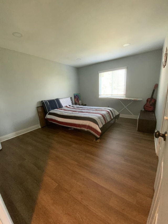 bedroom with dark wood-type flooring