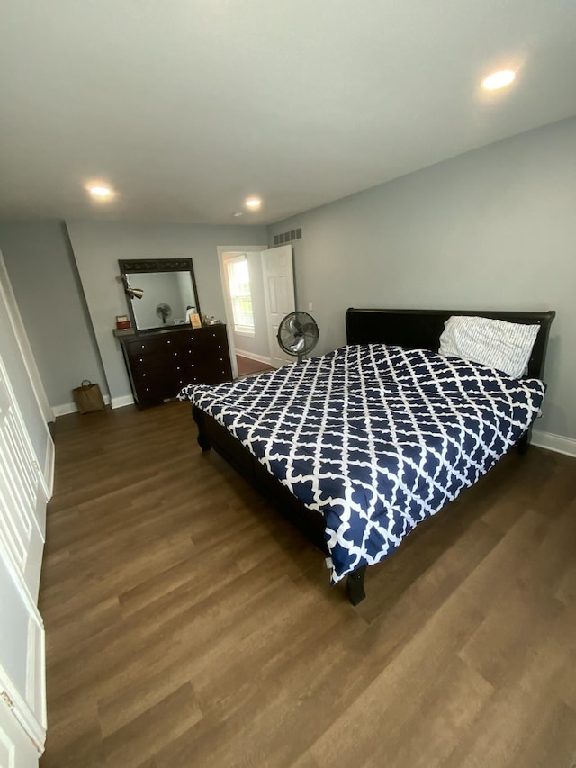 bedroom with dark wood-type flooring