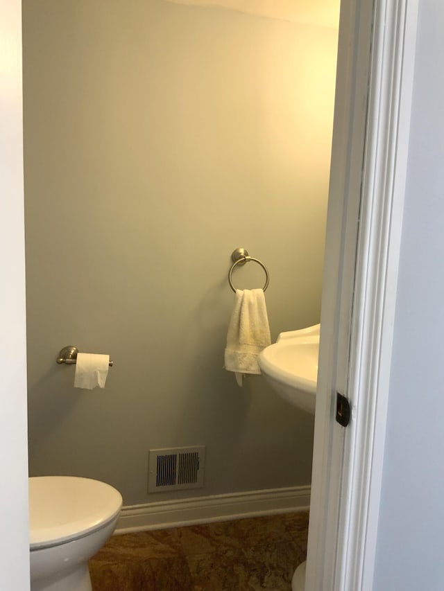 bathroom featuring toilet and sink