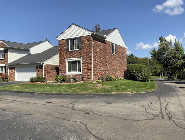 view of property exterior featuring a garage and a lawn