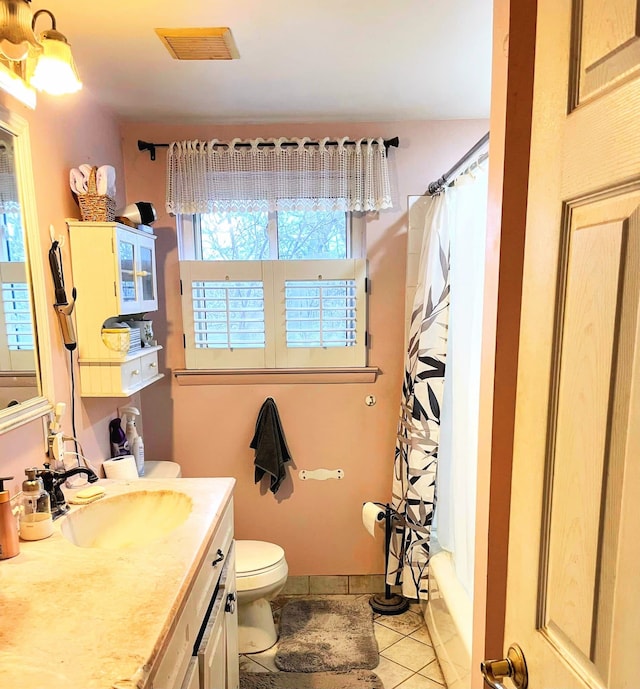 full bathroom featuring vanity, tile patterned flooring, shower / bath combination with curtain, and toilet