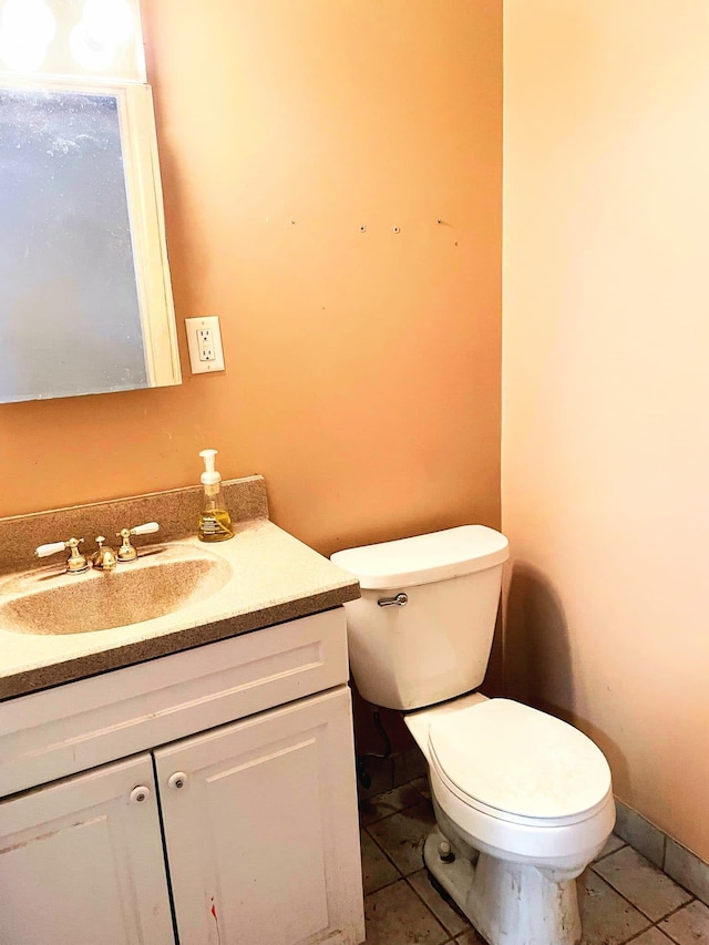 bathroom featuring tile patterned floors, vanity, and toilet