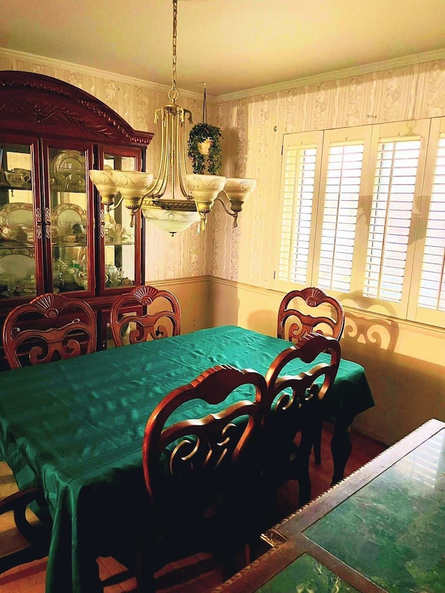 dining area featuring a healthy amount of sunlight and ornamental molding