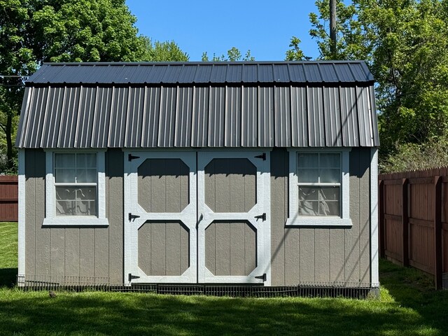 view of outbuilding with a lawn