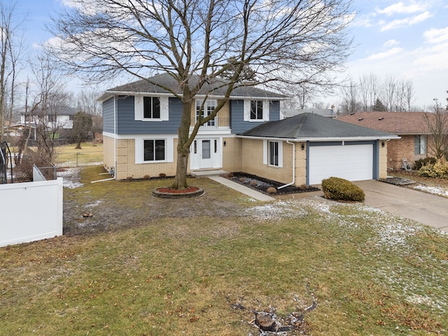 view of front property featuring a garage and a front yard