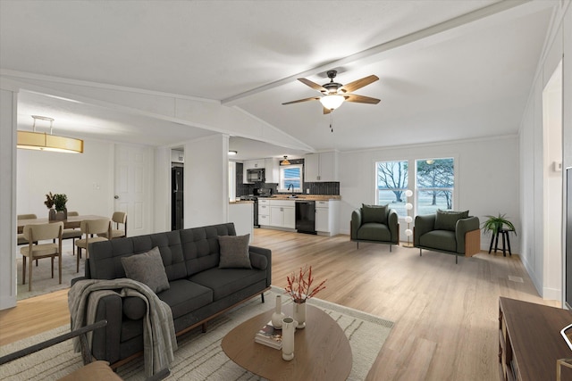 living room featuring ceiling fan, light hardwood / wood-style floors, and vaulted ceiling with beams