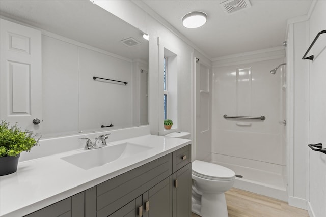 bathroom with vanity, hardwood / wood-style flooring, a shower, and toilet