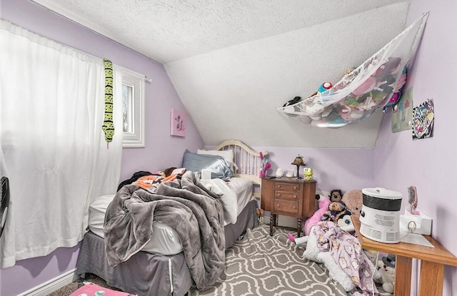 bedroom featuring vaulted ceiling and a textured ceiling