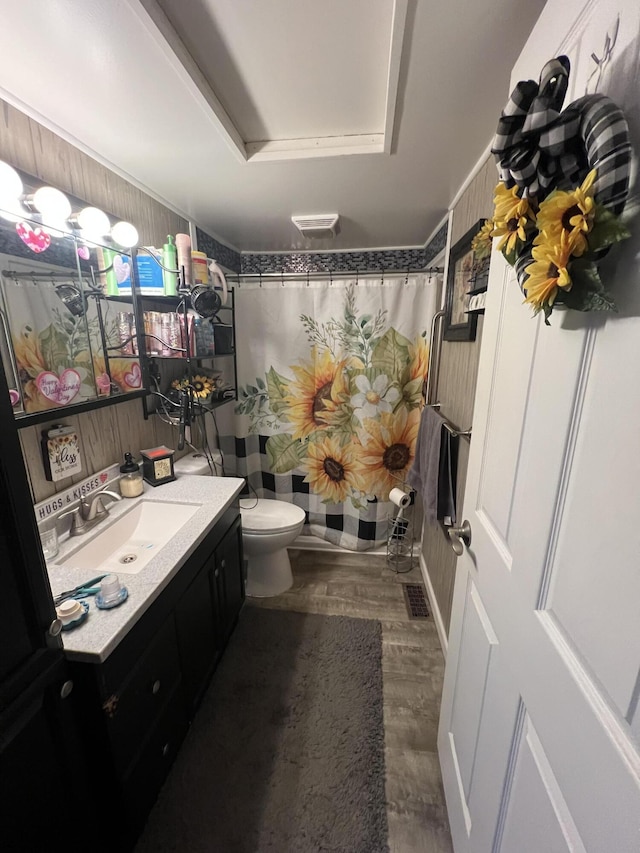 bathroom with wood-type flooring, vanity, toilet, a raised ceiling, and a shower with curtain